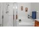 Modern bathroom showcasing a glass-enclosed shower and a relaxing soaking tub at 25332 Lexington Oaks Blvd, Wesley Chapel, FL 33544