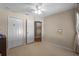 Bedroom with neutral walls, carpet, ceiling fan, and closet at 25332 Lexington Oaks Blvd, Wesley Chapel, FL 33544