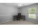 Minimalist bedroom with natural light, a ceiling fan, and carpet floors at 25332 Lexington Oaks Blvd, Wesley Chapel, FL 33544