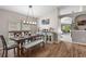 Dining room featuring hardwood floors, large windows for natural light, and stylish decor at 25332 Lexington Oaks Blvd, Wesley Chapel, FL 33544