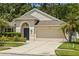Charming single-Gathering home featuring a 2-car garage, arched entry, and well-maintained landscaping at 25332 Lexington Oaks Blvd, Wesley Chapel, FL 33544
