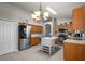 Spacious kitchen with stainless steel appliances, center island, wood cabinets, and ample counter space at 25332 Lexington Oaks Blvd, Wesley Chapel, FL 33544