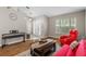 Open living room with a piano, bright window, comfortable seating, and hardwood floors at 25332 Lexington Oaks Blvd, Wesley Chapel, FL 33544