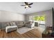 Cozy living room featuring a large sectional sofa and sliding glass door to the patio at 25332 Lexington Oaks Blvd, Wesley Chapel, FL 33544