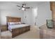 Main bedroom features carpeted floors and an ornate wooden bed frame at 25332 Lexington Oaks Blvd, Wesley Chapel, FL 33544