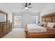 A main bedroom featuring carpeted floor and a large bed at 25332 Lexington Oaks Blvd, Wesley Chapel, FL 33544