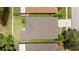 An aerial image shows the roof and backyard bordered by lush green space and a pond at 25332 Lexington Oaks Blvd, Wesley Chapel, FL 33544