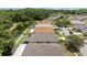Aerial view of a neighborhood showcasing rooftops, green lawns, a pool and scenic pond at 25332 Lexington Oaks Blvd, Wesley Chapel, FL 33544