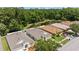 Aerial view features the rooftops of single-Gathering homes and adjacent pond at 25332 Lexington Oaks Blvd, Wesley Chapel, FL 33544