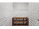 Walk-in closet with white wire shelving and a dark brown cubby organizer at 25332 Lexington Oaks Blvd, Wesley Chapel, FL 33544