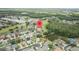 An aerial view showcases a neighborhood surrounded by golf courses, lakes, and lush greenery, complete with an in-community golf course at 25942 Risen Star Dr, Wesley Chapel, FL 33544