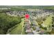 This aerial shows a neighborhood with golf course views, a lake, and beautiful surrounding green space, showing a community at 25942 Risen Star Dr, Wesley Chapel, FL 33544