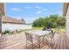 Deck with a dining table set in a well-maintained backyard with fencing at 25942 Risen Star Dr, Wesley Chapel, FL 33544
