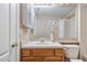 Bathroom features a wood vanity, large mirror, white countertop and décor at 25942 Risen Star Dr, Wesley Chapel, FL 33544