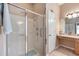 Clean bathroom featuring glass enclosed shower with chrome fixtures, grab bar, and tile surround at 25942 Risen Star Dr, Wesley Chapel, FL 33544