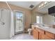 Bathroom has a walk-in shower, vanity and walk-out to the backyard at 25942 Risen Star Dr, Wesley Chapel, FL 33544