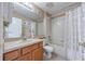 Well-lit bathroom with a vanity, mirror, and a shower-tub combination with white tile surround at 25942 Risen Star Dr, Wesley Chapel, FL 33544