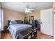 This bedroom offers wood floors, ceiling fan, and a desk area at 25942 Risen Star Dr, Wesley Chapel, FL 33544
