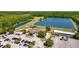 An aerial showing the golf course club house, parking lot and a view of a pond on the course at 25942 Risen Star Dr, Wesley Chapel, FL 33544