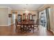 Spacious dining room boasts wood floors, a chandelier, and a large glass door to the patio at 25942 Risen Star Dr, Wesley Chapel, FL 33544