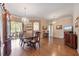 Formal dining room featuring hardwood floors, large table, china cabinet, and chandelier lighting at 25942 Risen Star Dr, Wesley Chapel, FL 33544