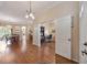 Elegant foyer leading to dining area and office, featuring hardwood floors and tasteful lighting at 25942 Risen Star Dr, Wesley Chapel, FL 33544