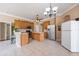 Bright kitchen featuring tiled floors, wood cabinets, stainless steel appliances, and a center island at 25942 Risen Star Dr, Wesley Chapel, FL 33544