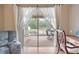 Tranquil view from the bedroom onto the screened lanai and backyard with mature trees at 25942 Risen Star Dr, Wesley Chapel, FL 33544