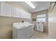 Well-equipped laundry room with a sink, countertop, and washer and dryer at 25942 Risen Star Dr, Wesley Chapel, FL 33544