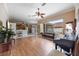 Spacious living room with hardwood floors and a large sliding glass door and an open kitchen at 25942 Risen Star Dr, Wesley Chapel, FL 33544