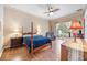 Serene main bedroom featuring a four-poster bed and a private door to the lanai at 25942 Risen Star Dr, Wesley Chapel, FL 33544