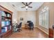 Dedicated office space with hardwood floors, ample lighting, and built-in shelving at 25942 Risen Star Dr, Wesley Chapel, FL 33544