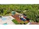 A colorful community playground with slides, swings, and climbing structures, surrounded by a safety fence at 25942 Risen Star Dr, Wesley Chapel, FL 33544
