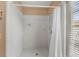 The bright white bathroom features a walk-in shower and a window at 25942 Risen Star Dr, Wesley Chapel, FL 33544