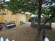 View of backyard with wash station, outdoor seating, and mature trees at 2624 54Th S St, Gulfport, FL 33707