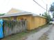 One-story home featuring colorful exterior art and a privacy fence at 2624 54Th S St, Gulfport, FL 33707
