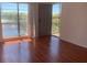 Bedroom featuring hardwood floors, large windows with fountain views, and a private balcony at 2625 State Road 590 # 2832, Clearwater, FL 33759
