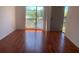 Bright bedroom featuring hardwood floors, a large window with lake views, and a private balcony at 2625 State Road 590 # 2832, Clearwater, FL 33759