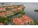 Aerial view featuring waterfront residences, pool, and amenities with a scenic coastal backdrop at 2739 Via Capri # 1011, Clearwater, FL 33764