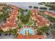 Aerial view of residential area, a community pool, and beautifully landscaped grounds by the water at 2739 Via Capri # 1011, Clearwater, FL 33764