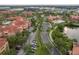 Aerial view showcases the community's pool, clubhouse, and multiple apartment buildings with lush greenery at 2739 Via Capri # 1011, Clearwater, FL 33764