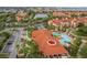 Aerial view of community pool, clubhouse, and well-maintained grounds with residential buildings at 2739 Via Capri # 1011, Clearwater, FL 33764