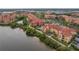 Aerial view of a residential area, waterfront features, and a pool, showcasing lush landscaping at 2739 Via Capri # 1011, Clearwater, FL 33764