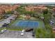 Aerial view of the condo community with a tennis court and parking at 2739 Via Capri # 1011, Clearwater, FL 33764