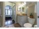 Bathroom features granite countertop, white vanity and decorative plant with view into the bedroom at 2739 Via Capri # 1011, Clearwater, FL 33764