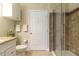 Bathroom features white vanity, granite countertop and tiled shower with glass doors at 2739 Via Capri # 1011, Clearwater, FL 33764