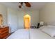 Bright bedroom features neutral tones, a ceiling fan and a glimpse of a doorway to the next room at 2739 Via Capri # 1011, Clearwater, FL 33764