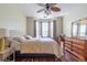 Bedroom with hardwood floors, ceiling fan, natural light, and traditional furnishings at 2739 Via Capri # 1011, Clearwater, FL 33764