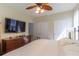 Bedroom with a ceiling fan, hardwood floors, and an attached bathroom and closet at 2739 Via Capri # 1011, Clearwater, FL 33764