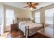 Bedroom with hardwood floors, a decorative ceiling fan, and lots of natural light from the windows at 2739 Via Capri # 1011, Clearwater, FL 33764